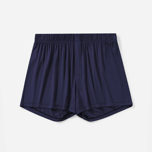 A pair of navy blue lounge boxer shorts made from TENCEL™ Modal fabric.