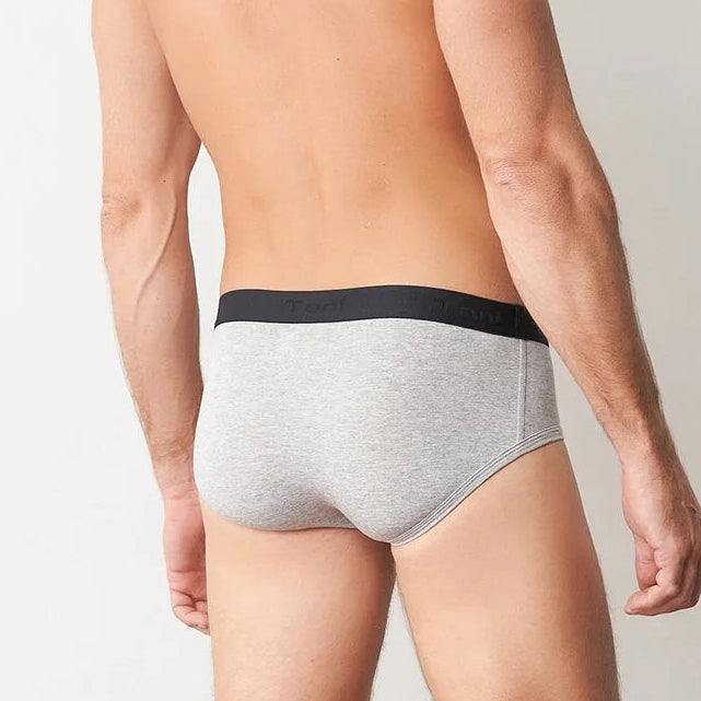 Man wearing gray underwear with black waistband on a plain background