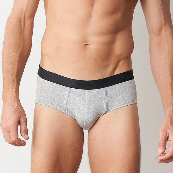 Man wearing gray underwear with a black waistband on a plain background