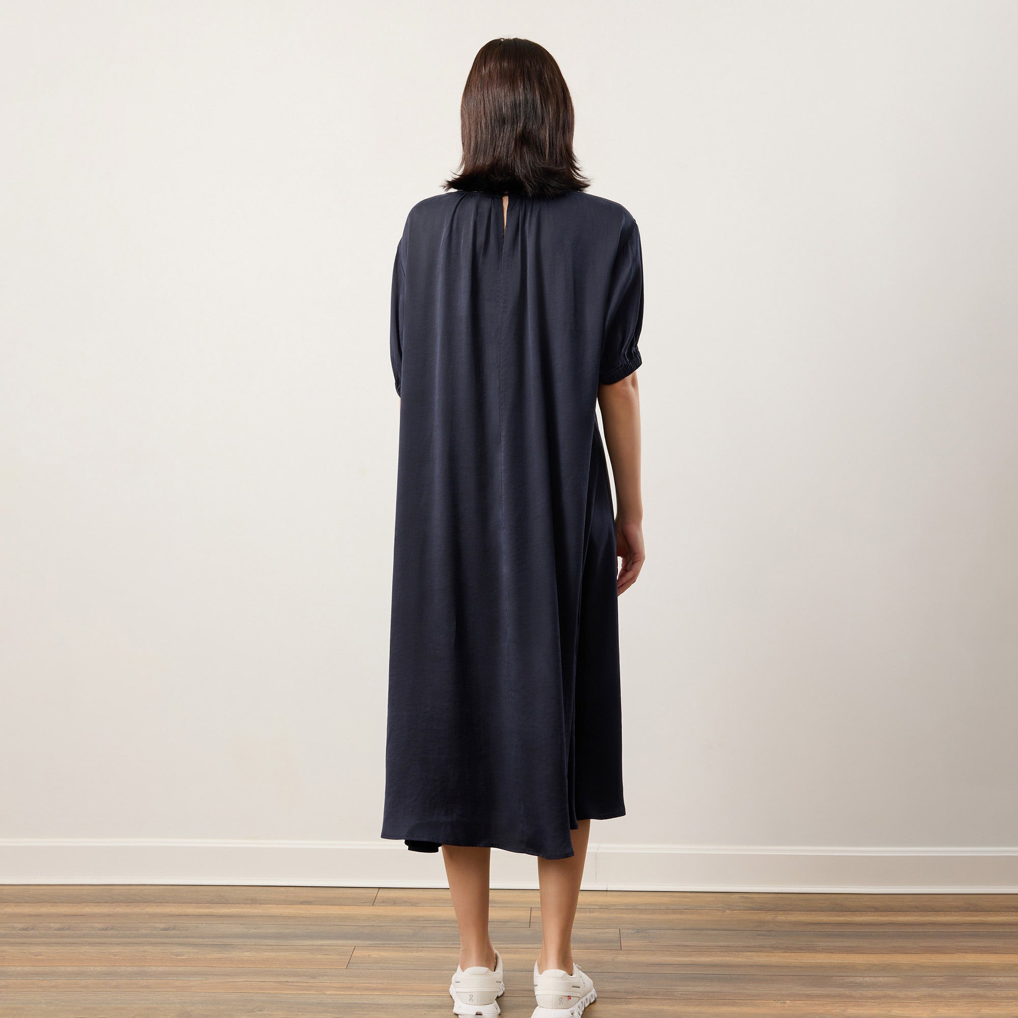 Elegant Flow TENCEL™ LUXE maxi dress with puffed sleeves and soft pleats, eco-friendly fabric.