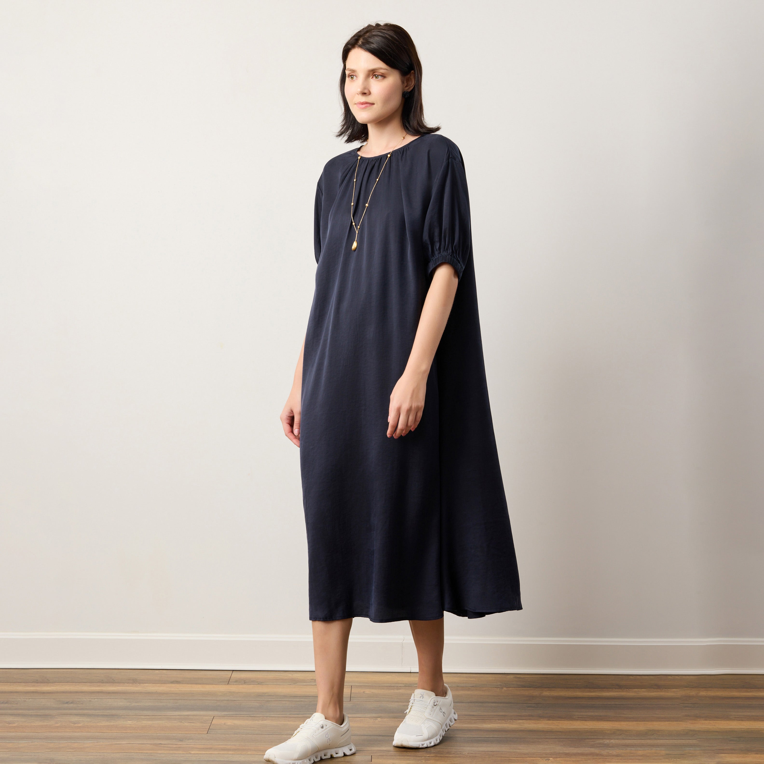 Elegant Flow TENCEL™ LUXE puffed sleeve maxi dress with soft pleats and eco-friendly fabric.