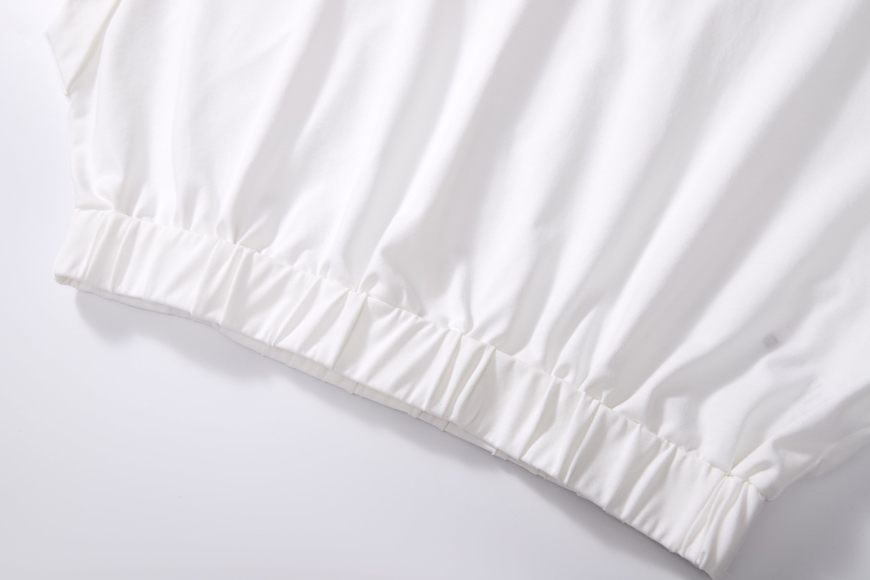 Chic cotton cap sleeve crop top in breezy fabric, perfect for effortless style and eco-friendly wear.