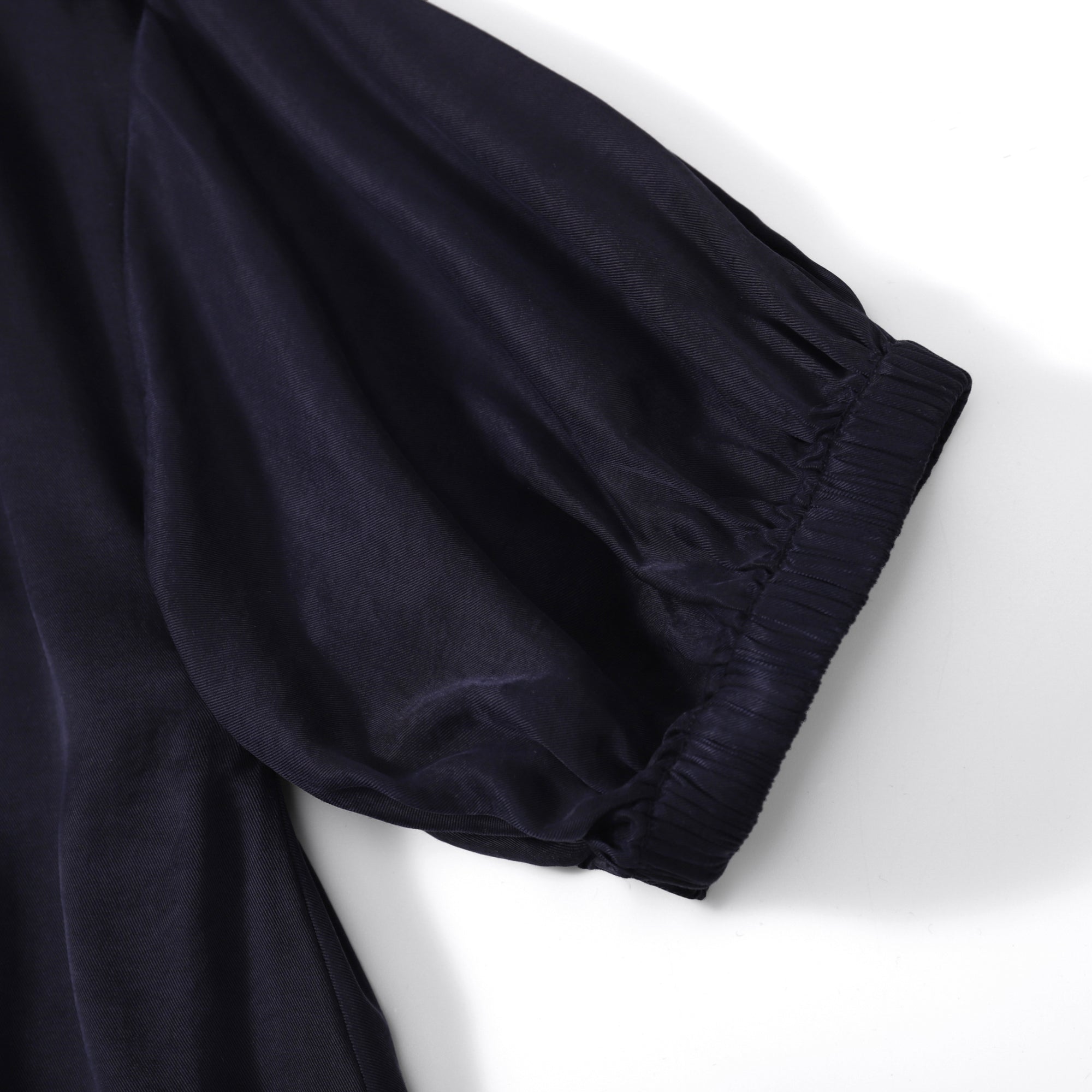 Elegant Flow TENCEL™ LUXE maxi dress with puffed sleeves and soft pleats, eco-friendly design.